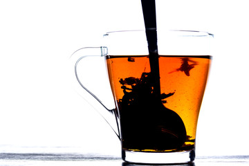 tea in a transparent mug on a white background
