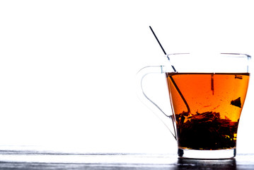 tea in a transparent mug on a white background