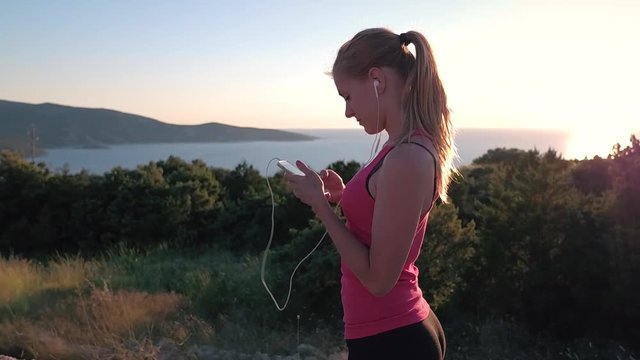 Slow motion - Girl stops mid running to check her phone and starts running again