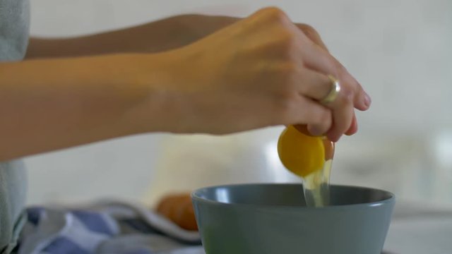 The process of making cream for a cake. Pastry Chef pour eggs into a bowl