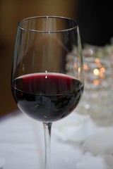 Red wine in a clear glass, with bokeh in thebackground