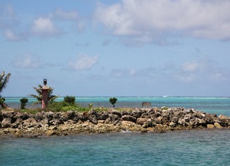 Rocky island with a small lighthouse facing Saipan lagoon Northern Mariana Islands