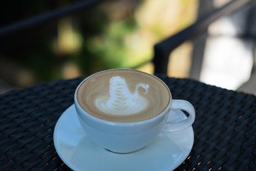 A cup of latte on the table.