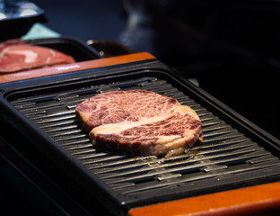 Grilled wagyu beef, Raw marble beef steak frying in black grill pan