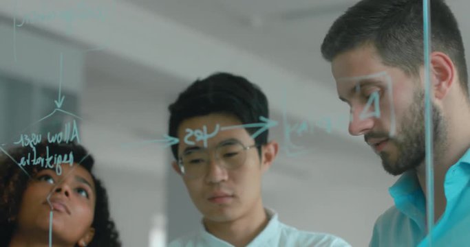 Multi racial team of employees drawing and discussing flowchart diagram in a modern office. 4K UHD 60 FPS SLOW MOTION