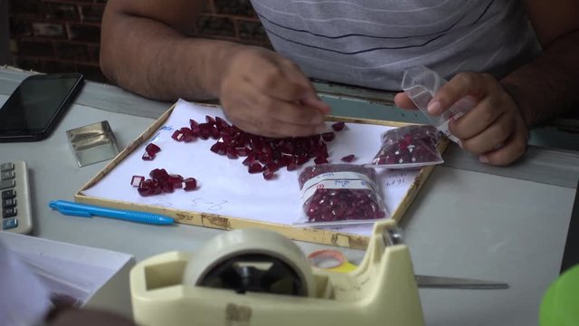 A trader displays gemstone or crystal in the trading market THAILAND, where buyers and sellers meet.