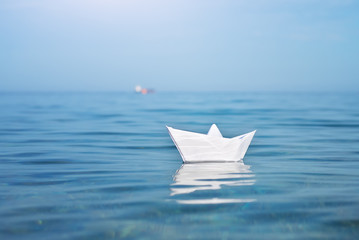 Paper toy ship and deep blue sea.