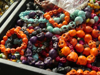 Naklejka na ściany i meble A tray full of colorful skull-designed stone bracelets and wristbands