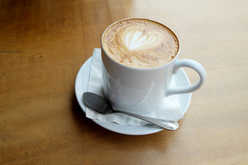 Hot latte on a wooden table