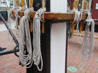 Ropes tied to a post in a yacht club marina