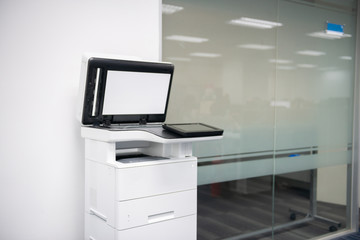 White modern laser multi function printer in the office location