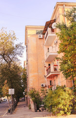Fototapeta na wymiar Side view on the ancient four-storeyed house on the gordsky street in the early fall.