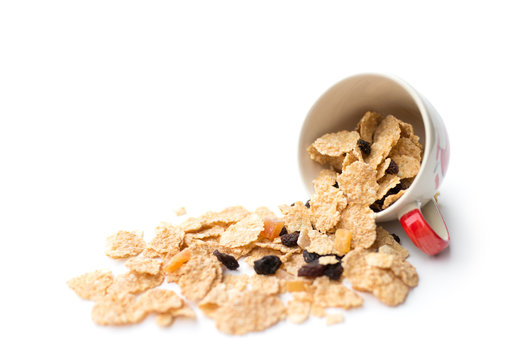 whole grain cereal flakes which mixed berry fruit and raisins for breakfast isolaed on white background