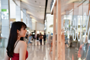 Naklejka na ściany i meble Shopping Concept. Asian girls are shopping in the mall. Beautiful women are happy to shop in the mall. Beautiful girl walking in the mall.