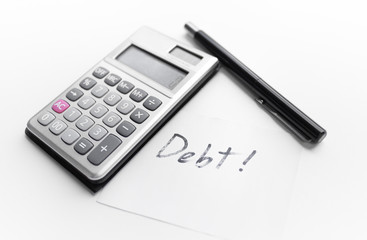 calculator with a pen and paper note with debt word isolated on white background