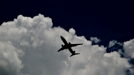Low angle view airplane against clouds