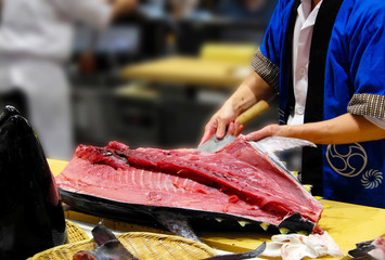 The chef cutting tuna in restaurant