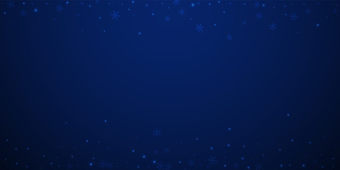 Sparse glowing snow Christmas background. Subtle f