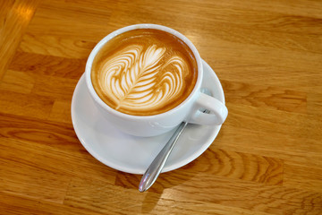 Latte cup Art on a wooden table