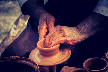 Potter`s hands shaping up the clay