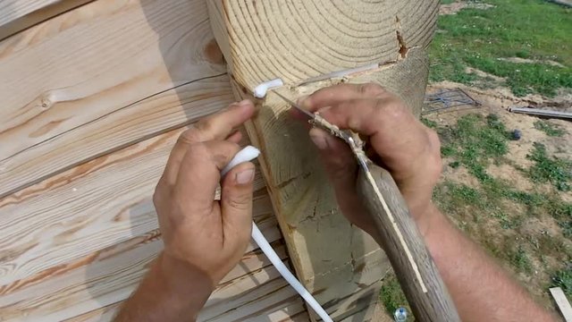 Sealing joints and cracks silicone sealant and insulation, insulation, painting a wooden house at the height of painting, a syringe for paint and sealant at the height of a metal tree 