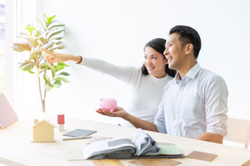 Obraz premium Happy couple plan buying house.Concept for Couple saving money for buy home and real estate. Select material for decorate furniture.