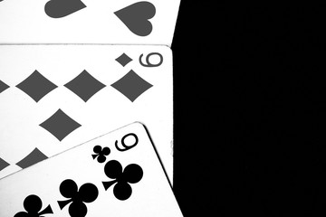 Playing cards on a dark background close up. Black and white