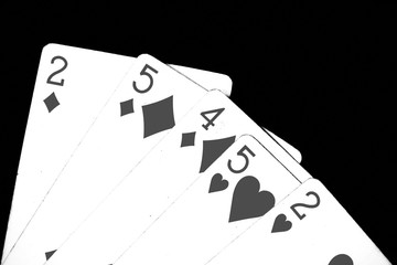 Playing cards on a dark background close up. Black and white