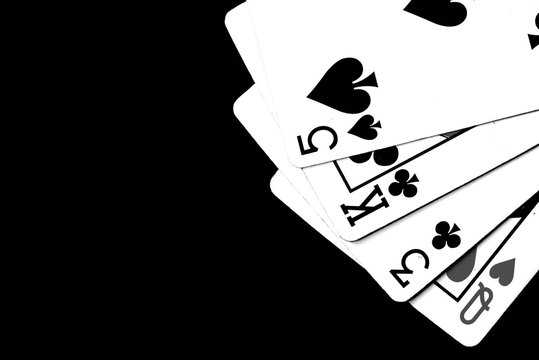 Playing cards on a dark background close up. Black and white