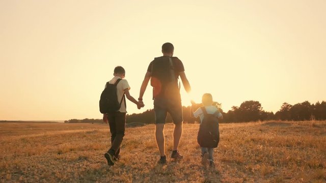 A happy family travels the world. Father and two sons are engaged in outdoor tourism. The concept of a healthy lifestyle and a happy family