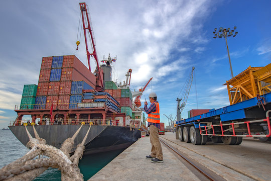 the loading and discharging operation container ship vessel in port takes control by stevedore and foreman in charge, working in port terminal being for logistics and transport services to worldwide.