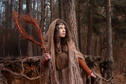 a witch in rags conjures in forest