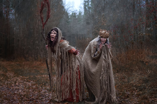 two witches in rags in forest