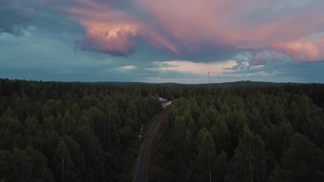 Drone shot of railway track surrounded by forest trees, Nurmes, Finland