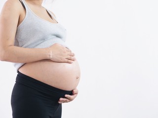 Close up pregnancy woman over white background.