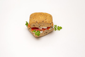 Sandwich with salmon, cheese and cereal bread on white background. Close up.