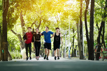 Group asia join teenagers are running in the morning with fresh air in the park. Running a good exercise helps the body system burn excess fat. Give a good respiratory system. make you feel relaxed.