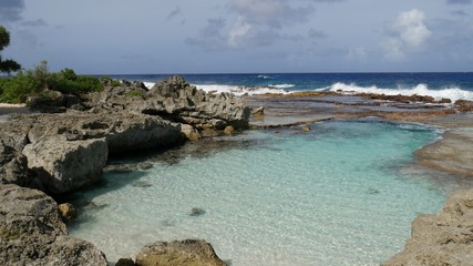 Wide view of the natural swimming hole on Rota, Northern Mariana Islands, one of the most popular attractions the island has to offer. 