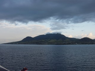 Wide shot of the island of St. Kitts, West Indies seen from the water approaching the Port Zante terminal