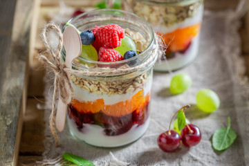 Healthy oat flakes with fresh fruits and yoghurt in jar