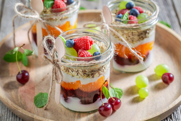 Sweet oat flakes in jar with yoghurt and berry fruits