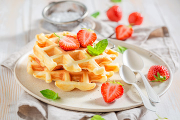 Sweet wafers with powdered sugar and fruits