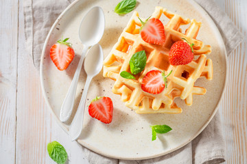 Delicious wafers with fresh strawberries and sugar