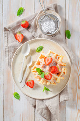 Tasty wafers with fresh strawberries and sugar