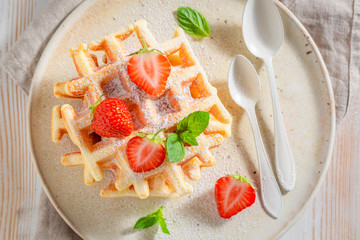 Delicious wafers with strawberries and mint leaves