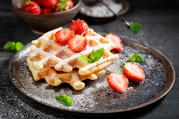 Homemade wafers with strawberries and mint leaves