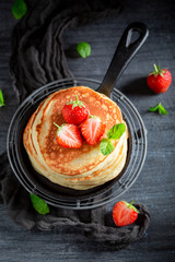 American pancakes with powdered sugar and strawberries