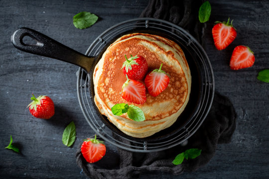 Homemade american pancakes for breakfast on dark table