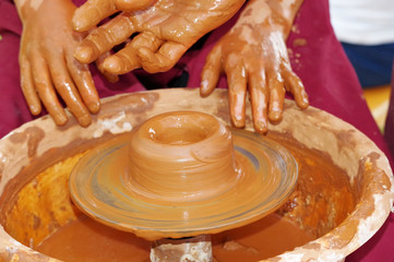 potter making a clay cup
