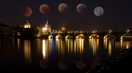 The Charles Bridge over the Vltava River, in Prague with total eclipse of moon